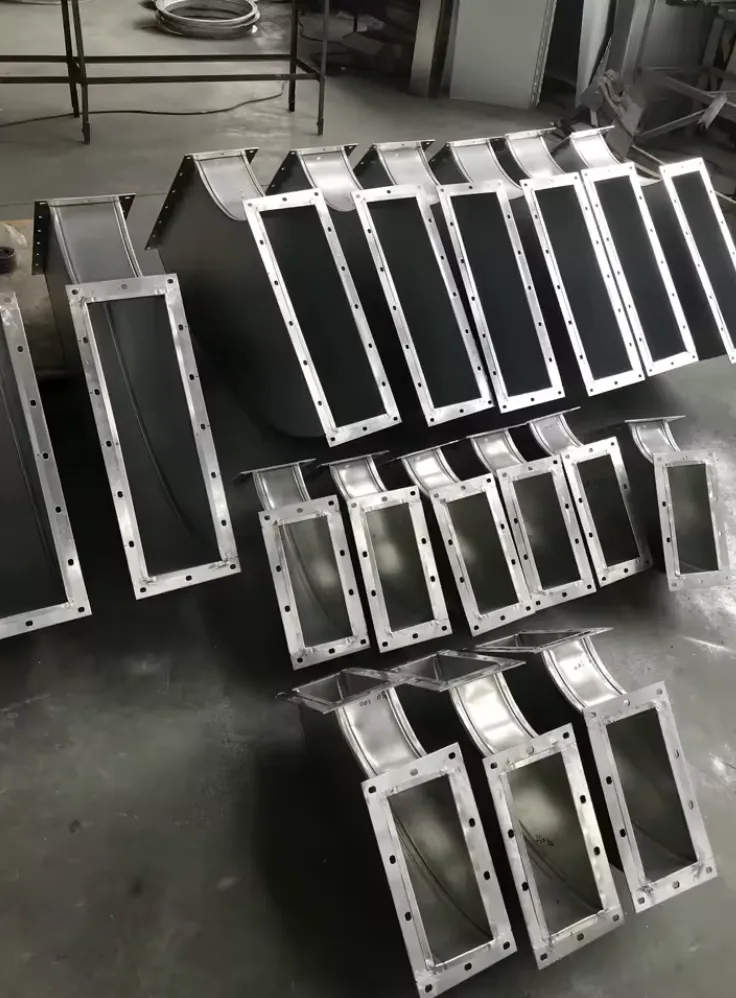 Round elbow-style HVAC fitting assembled from light-gauge sheet metal on a workbench