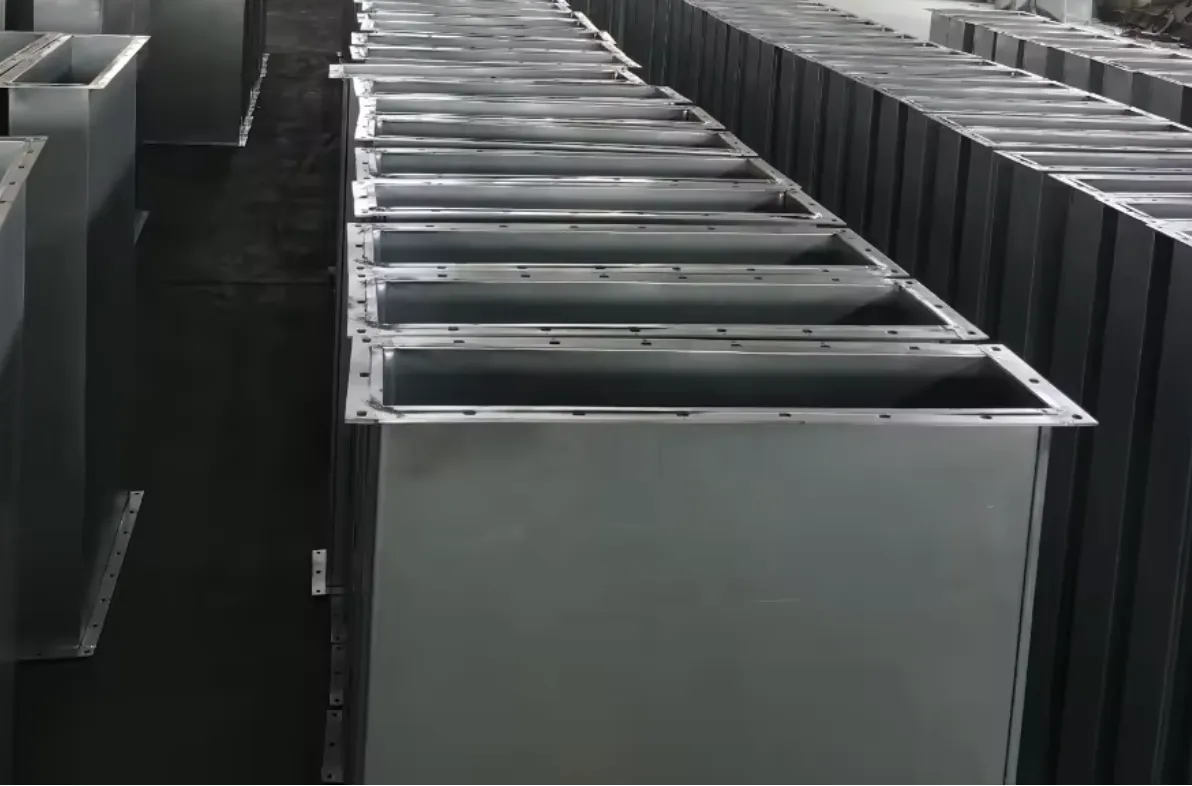 Stacked straight rectangular duct sections staged on a wood pallet in the shop